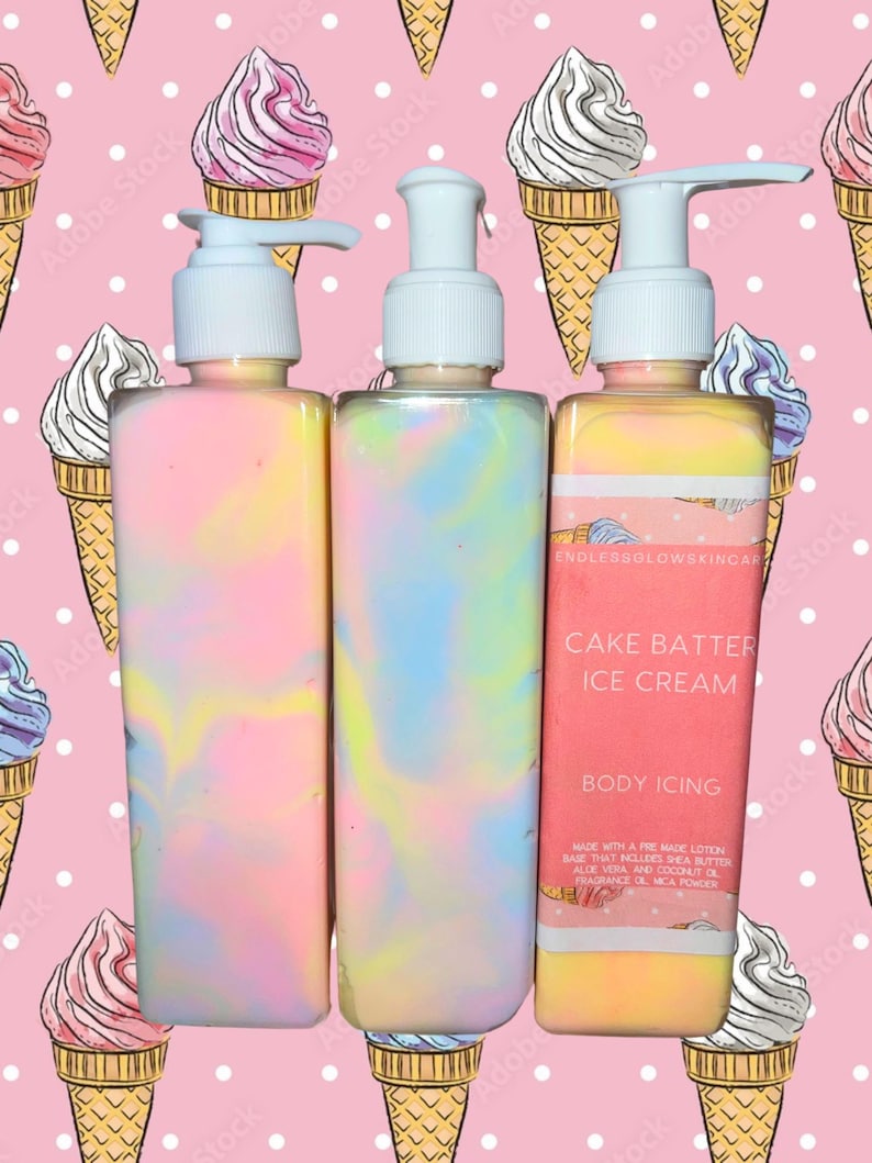 May include: Three colorful body icing bottles with pump dispensers. The bottles have a pastel swirl design and are labeled "Cake Batter Ice Cream Body Icing." The background features a pink pattern of ice cream cones and polka dots.