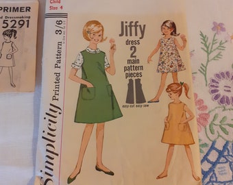 May include: Simplicity sewing pattern number 5291 for a child's Jiffy dress. The pattern includes two main pieces and is easy to cut and sew. The pattern cover features three illustrations of girls wearing different versions of the dress.