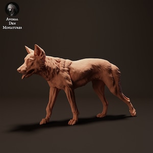 May include: A detailed, unpainted miniature of a wolf, sculpted in a realistic pose with its tongue sticking out. The miniature is made of a light brown, clay-like material.
