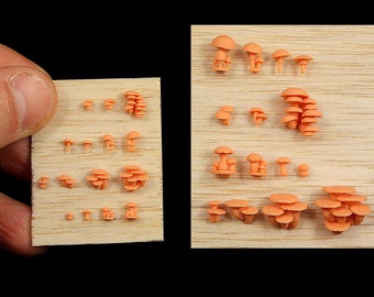 May include: Two wooden boards with rows of miniature orange mushroom sculptures. The mushrooms are arranged in different sizes and clusters.