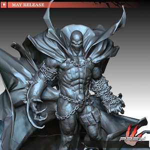 May include: A grey 3D-rendered figurine of a muscular character wearing a large flowing cape, chains across the chest and waist, and spiked gauntlets. The figure features a skull-adorned belt and mask. Text at the top reads MAY RELEASE and PREY.