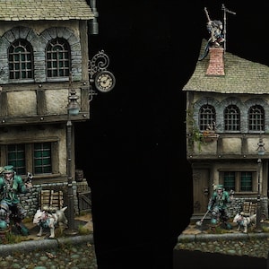 May include: A miniature model of a two-story building with a clock on the side. The building has a green roof and a brown door. There is a figure standing on the roof with a gun. A figure with a green jacket and a dog are standing in front of the building.