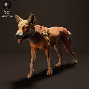 May include: A detailed miniature figurine of a red fox, standing on all four legs with its mouth slightly open. The figurine is made of a light brown material and has a realistic appearance.