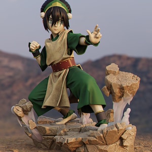 May include: A detailed figurine of a character in a fighting stance, wearing a green and tan outfit with a brown belt. The figure is posed on a rocky base with a light-colored, cloudy effect. The character has black hair and is wearing a headband.