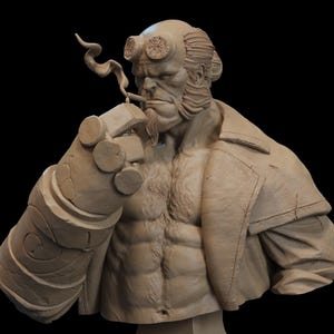 May include: A tan-colored bust sculpture of a muscular humanoid figure with horns, a goatee, and a large mechanical right hand. The figure wears a coat and is depicted smoking a cigarette with a visible trail of smoke rising from the tip.