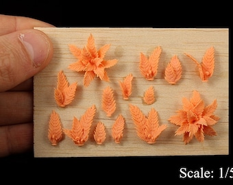 May include: A set of 14 miniature orange plastic plants on a wooden surface. The plants are in various shapes and sizes, and are designed to be used as model railroad scenery. Scale: 1/50.