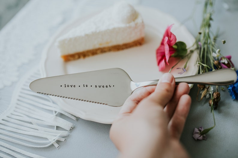 Cake shovel server in silver color with hand stamped text love is sweet