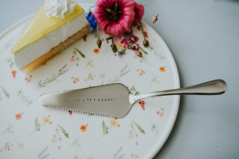 Cake shovel server in silver color with hand stamped text love is sweet