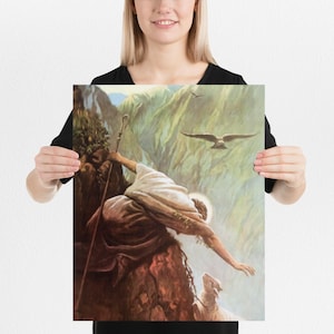 May include: A painting depicting a shepherd reaching down from a cliff to rescue a lost sheep. The shepherd is wearing a brown robe and holding a staff. The sheep is white and is standing on a rocky ledge. The background is a mountainous landscape with a blue sky and white clouds.