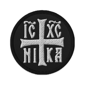 May include: A black embroidered patch with a white cross and the text "IC XC NIKA" in a circle.