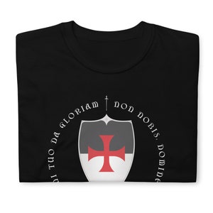 May include: Black t-shirt with a white and red shield and the text "Non Nobis, Domine, Non Nobis, Sed Nomini Tuo Da Gloriam".