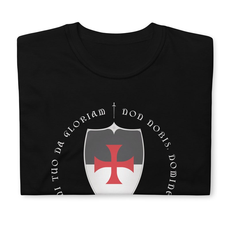 May include: Black t-shirt with a white and red shield and the text "Non Nobis, Domine, Non Nobis, Sed Nomini Tuo Da Gloriam".