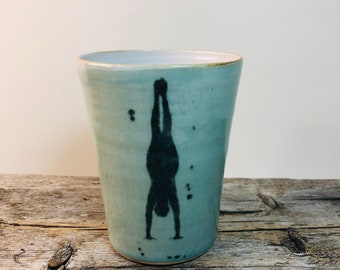 Handmade ceramic drinking cups for hot and cold drinks with a yoga motif, yoga cups in turquoise with an asana motif: headstand