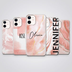 May include: Five clear smartphone cases featuring various pink and white marble-inspired patterns, gold-toned accents, and personalised text including the names Rose, Olivia, and Jennifer, along with individual letters S and E printed on the surfaces.