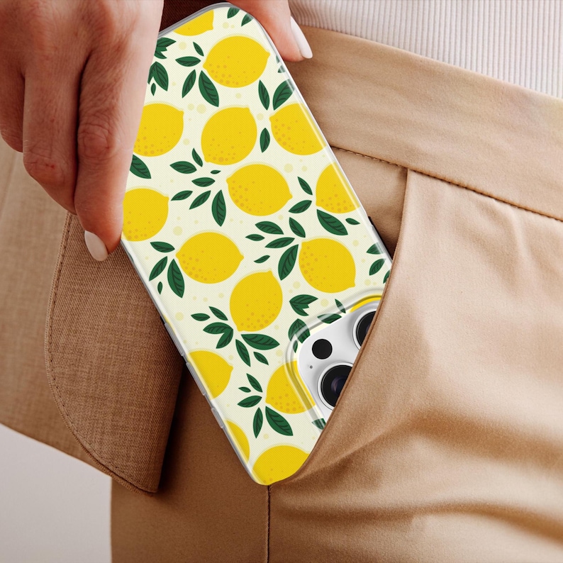 May include: A clear phone case with a white background and a repeating pattern of yellow lemons and green leaves.