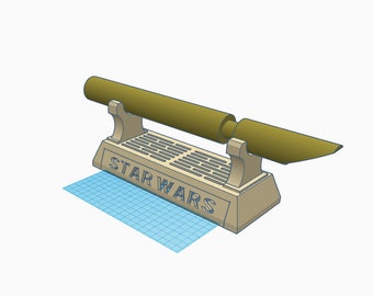 May include: A beige plastic stand with the words "STAR WARS" printed on the front. A brown lightsaber sits on top of the stand.