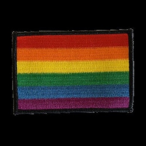 Könnte beinhalten: Ein Regenbogen-Pride-Flaggen-Patch mit roten, orangen, gelben, grünen, blauen und violetten Streifen. Der Patch ist von einem schwarzen Rand umgeben.