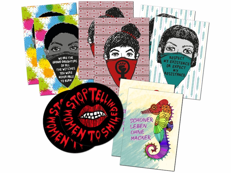 May include: A collection of art prints and coasters with bold graphics and text. The prints feature stylized faces with bandanas and empowering quotes. Coasters display a red lip design and the phrase "STOP TELLING WOMEN TO SMILE". A seahorse illustration is also present.