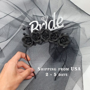 May include: Black bridal headband with a veil, black roses, and a silver 'Bride' sign with a diamond accent.