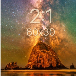 May include: A wall art print featuring a night sky filled with stars and a nebula above a large rock formation on a beach. The text 2:1 and 60x30 is printed in white in the centre. The scene displays orange, purple, and green hues.