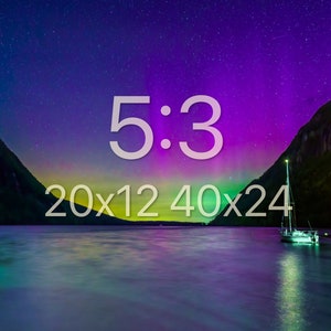 May include: A scenic landscape featuring a lake with a sailboat, mountains, and a vibrant night sky with the text "5:3 20x12 40x24". The sky transitions from purple to green, with a starry background.