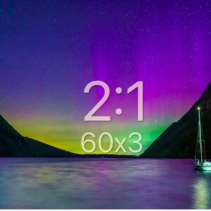 May include: A scenic landscape featuring a lake with a sailboat, mountains, and a starry sky with the text "2:1 60x3". The sky transitions from dark blue to purple and green. The image captures a serene night scene.