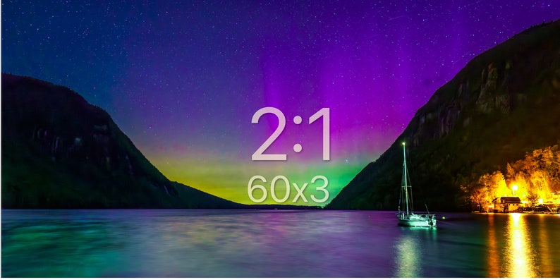 May include: A scenic landscape featuring a lake with a sailboat, mountains, and a starry sky with the text "2:1 60x3". The sky transitions from dark blue to purple and green. The image captures a serene night scene.
