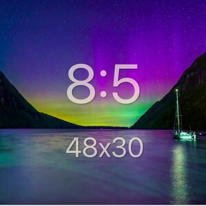 May include: A scenic landscape featuring a lake with a sailboat under a vibrant night sky. The sky displays a colorful aurora borealis with shades of purple, green, and blue. The image includes the text "8:5" and "48x30".