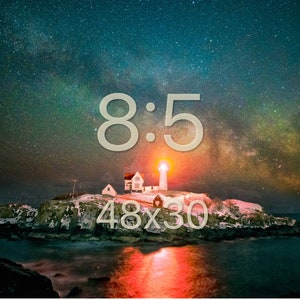 May include: A lighthouse on a rocky island with a starry night sky and the Milky Way visible. The lighthouse is lit up and the water is reflecting the light. The text "8:5" and "48x30" is superimposed on the image.