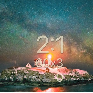 May include: A lighthouse on a rocky island with a starry night sky. The Milky Way is visible in the sky. The text "2:1 60x3 0" is visible in the image.