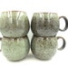 4 x Reactive Glaze Cuddly Stoneware Sphere Mugs in Sage Green with Coffee Speckles and a Cappuccino rim.