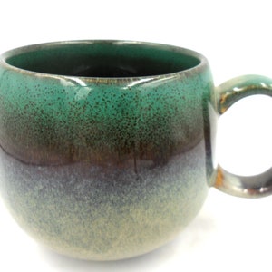 Reactive Glaze Cuddly Stoneware Sphere Mug in dark green.