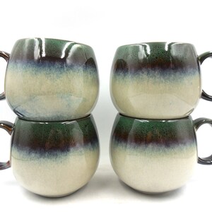 4 x Reactive Glaze Cuddly Sphere Stoneware Sphere Mugs in Dark Green and mist.