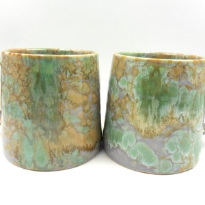 Set of 2 x Reactive Glaze Cuddly Brûlée Stoneware mugs in misty green, sand and mottled mauve tones.