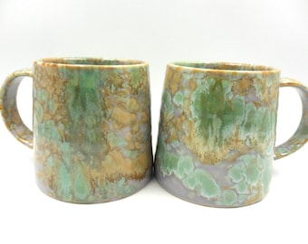 Set of 2 x Reactive Glaze Cuddly Brûlée Stoneware mugs in misty green, sand and mottled mauve tones.