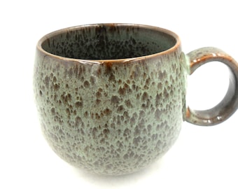 Reactive Glaze Cuddly Stoneware Sphere Mug in speckled green.