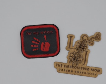 May include: Red embroidered patch with a handprint and the text "for my sisters". The patch is on a black background with a red border. The patch is made by The Embroidered Mom, a custom embroidery business.