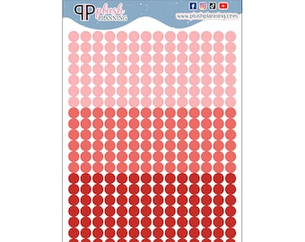 May include: A sheet of planner stickers with 100 red, pink, and light pink circles. The stickers are arranged in three rows of 10 circles each.