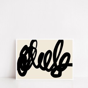 May include: Abstract art print featuring bold black brushstrokes on a cream background. The artwork showcases a dynamic, looping design, creating a modern and minimalist aesthetic. The print is framed in a white border.