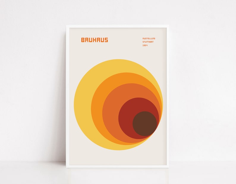 May include: A minimalist poster with the text "BAUHAUS" and "AUSSTELLUNG STUTTGART 1923" in a sans-serif font. The poster features a graphic design of concentric circles in shades of yellow, orange, and brown.