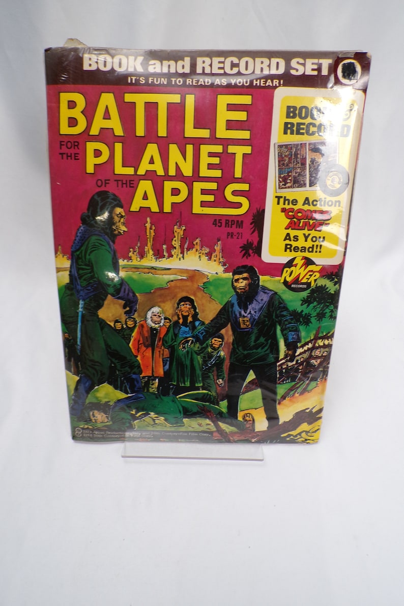 May include: A book and record set for "Battle for the Planet of the Apes". The cover features a colorful illustration of apes in a futuristic setting. The record is 45 RPM and the text on the cover reads "The Action Comes Alive As You Read!!"