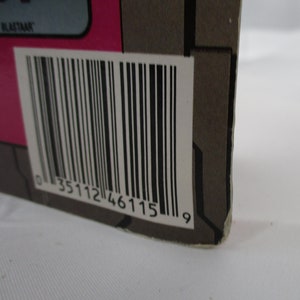 May include: Close-up of a black and white barcode with the number 0 35112 46115 9 printed below it.