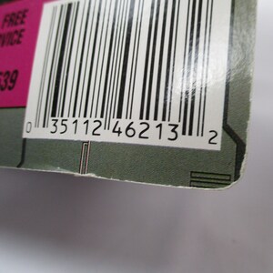 May include: Close-up of a product package corner with a barcode and the number "0 35112 46213 2". The package has a pink section with white text, including a toll-free customer service number.