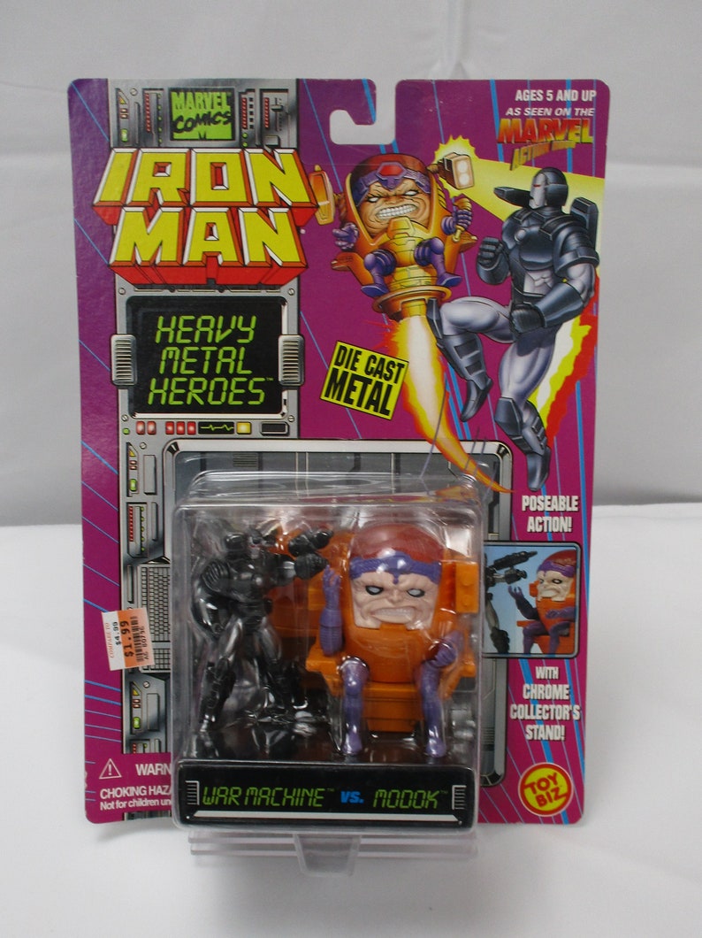May include: Iron Man Heavy Metal Heroes action figure set featuring War Machine vs. MODOK. The packaging is purple and features comic book art. The set includes two poseable figures and a chrome collector's stand.
