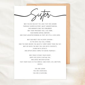 May include: A white card featuring the word "Sister" in cursive script, with a poem beneath. The card is presented on a neutral background, ideal for a sentimental gift or keepsake.