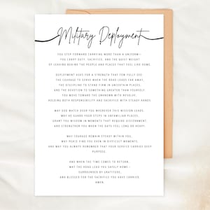 May include: A white card with the words "Military Deployment" in elegant script. The card contains a poem about military service, with text in a classic serif font. The card is set against a neutral background.