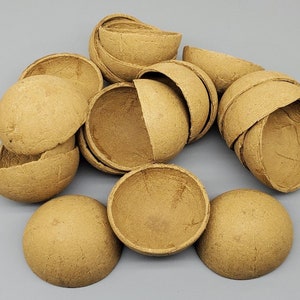 May include: A group of 13 brown paper mache bowls, some are whole and some are broken in half. The bowls are all the same size and shape.