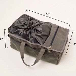 May include: A gray canvas tote bag with a drawstring top and a zippered pocket. The bag has two handles and measures 12.5 inches wide, 6.5 inches tall, and 7 inches deep.
