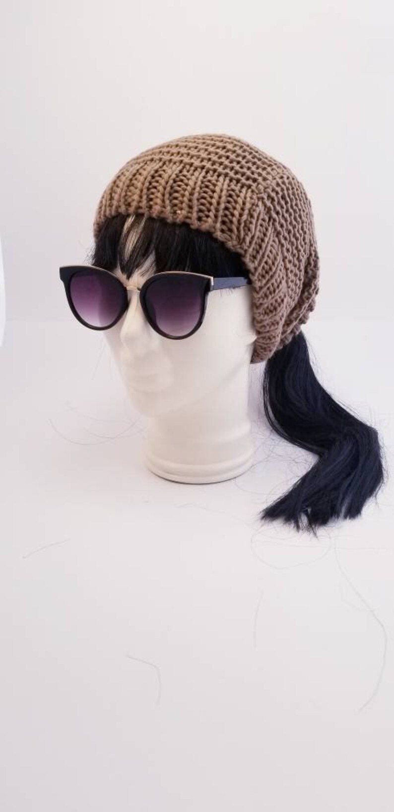 Taupe slouchy beanie with an elastic ponytail top opening great for any winter activity with style the comfort and the warmth.