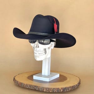 Black Felt Cowboy Hat, with an elastic sweat bandana for a comfort fit and incase a bit Big, Made in Mex. Rain Cover and feather included